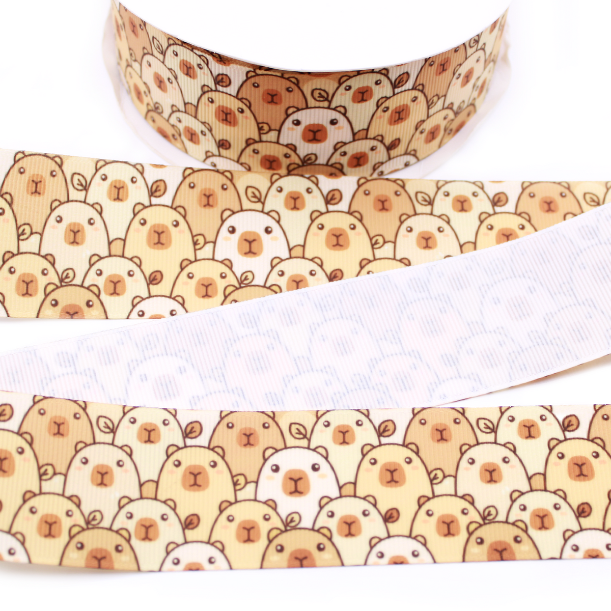 Capybara Faces printed grosgrain ribbon with rows of cute tan, cream and brown capybaras on a light cream background.