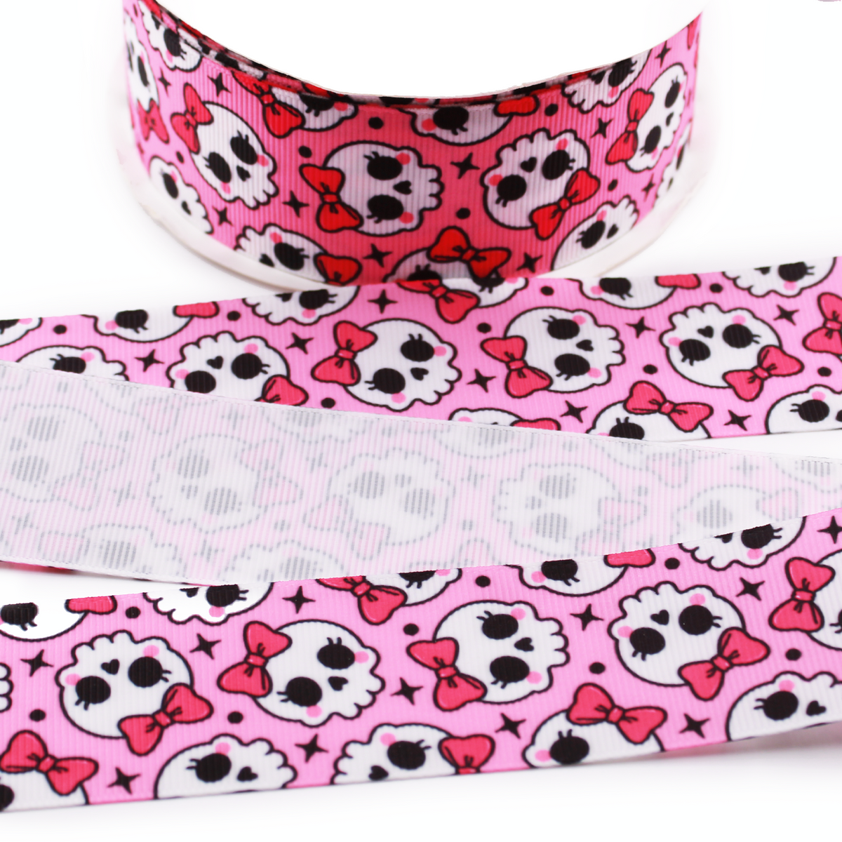 Coquette Skulls printed grosgrain ribbon with cute white skulls, pink bows and black stars on a bright pink background.