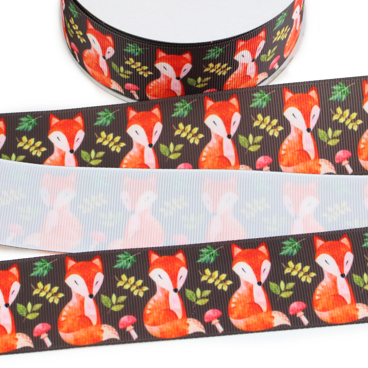 Fox printed grosgrain ribbon with orange woodland foxes, autumn leaves and mushrooms on a dark brown background.