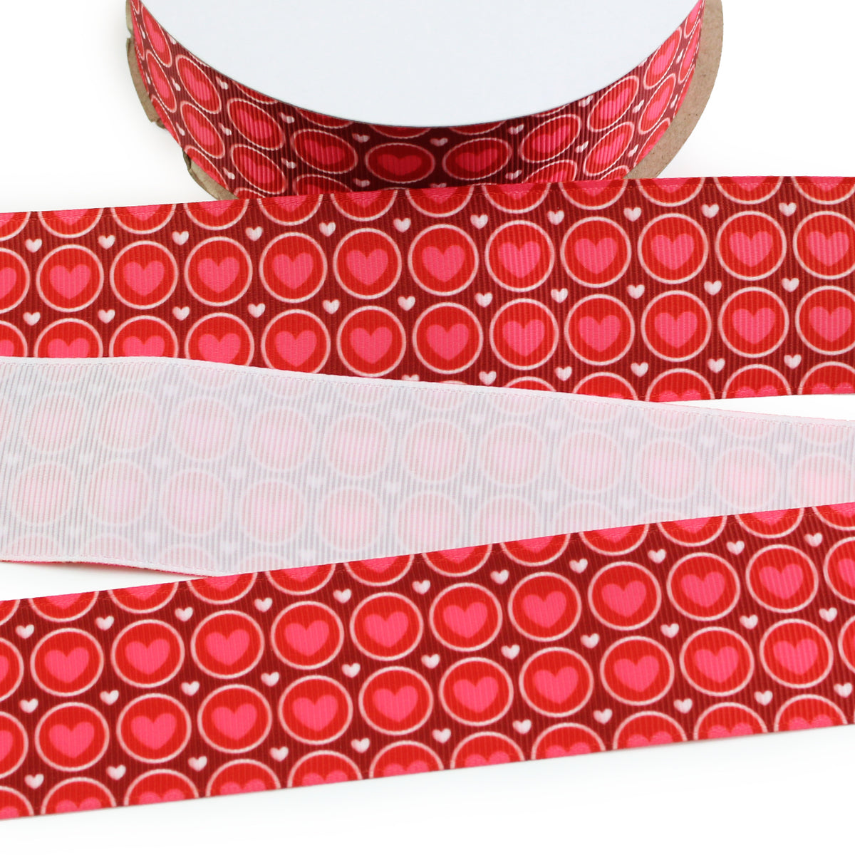 Retro Valentine Hearts printed grosgrain ribbon with pink hearts inside white outlined circles and tiny white hearts on a red background.