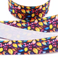 Colorful fall leaves printed grosgrain ribbon with yellow, orange, pink and blue leaves on a dark background.