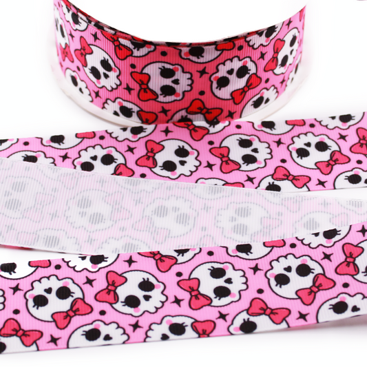 Coquette Skulls printed grosgrain ribbon with cute white skulls, pink bows and black stars on a bright pink background.
