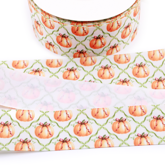 Pumpkin trellis printed grosgrain ribbon featuring watercolor orange pumpkins with bows and a green lattice pattern on a white background.