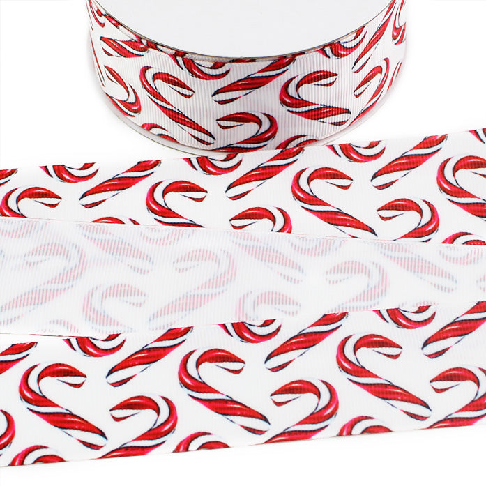 Christmas printed grosgrain ribbon featuring classic red and white striped candy canes scattered across a white background.