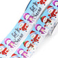 Let It Snow printed grosgrain ribbon with colorful snowmen wearing red, purple and green winter hats and scarves on a snowy blue background.