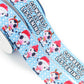 Christmas Cow printed grosgrain ribbon with cute black and white cows wearing Santa hats and reindeer antlers on a snowy blue background.
