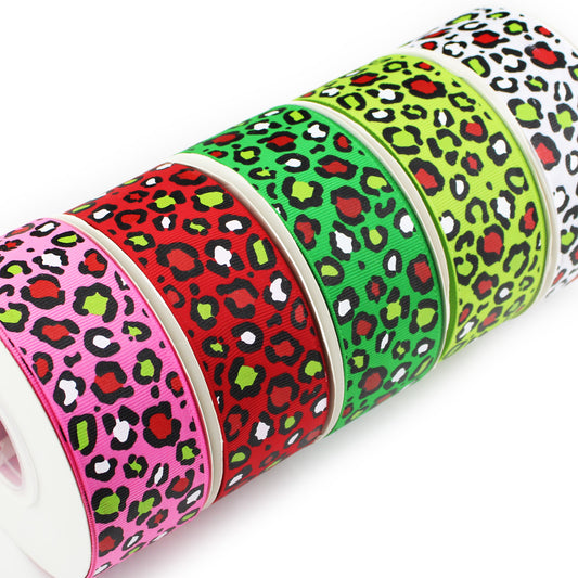 Christmas Leopard printed grosgrain ribbon with black leopard spots accented in red, green and white on pink, red, green, lime and white backgrounds.